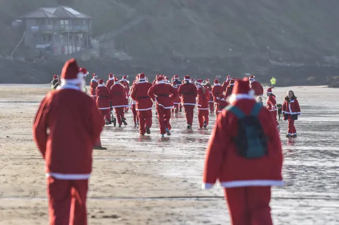 The annual santa run at Fistral Beach in Cornwall.  