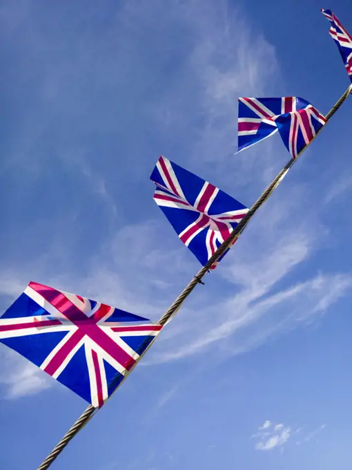 British Union Jack flags against a blue sky.