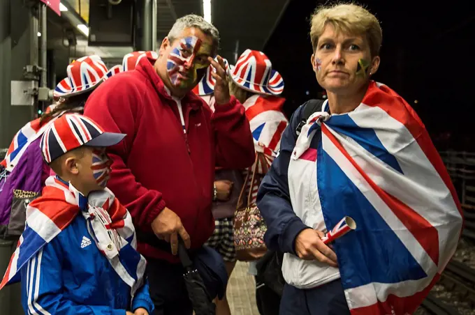 England, London, Stratford. A group of British fans return home after a day at a sporting event.