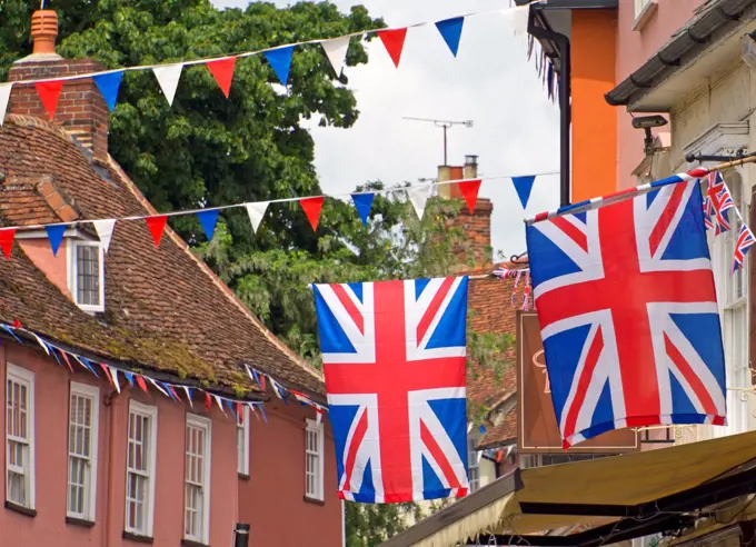 England, Essex, Saffron Walden. Union Jack flags and red white and blue bunting flying in Thaxted.