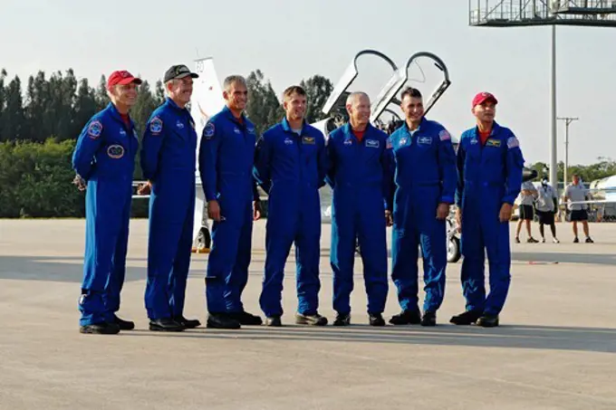 The crew of STS-117 arrives at Kennedy Space Center for launch. From right to left are Commander Rick Sturckow,  Pilot Lee Archambault, Mission Specialist Patrick Forrester, Steve Swanson, Jon Olivas, Jim Reilly and Clayton Anderson.