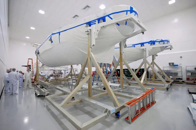 The Delta IV payload fairing (or cover) that will protect the GOES-O (Geostationary Operational Environmental Satellite) weather satellite during launch is prepared inside a cleanroom near Kennedy Space Center.