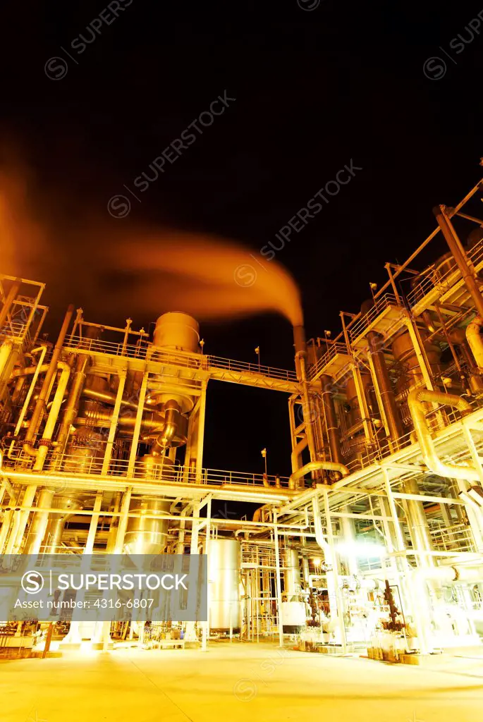 Large tomato processing factory at night, Central Valley, California, USA