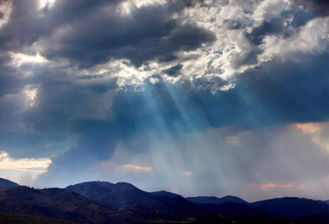 Crepuscular rays, dense plume of smoke from raging mountain wildfire, Colorado, USA