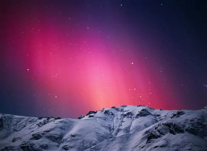 The Northern Light's auroral colors are produced when charged solar particles strike single atoms of oxygen at altitudes between 60 and 600 miles. This display occurred during a geomagnetic storm in the early evening hours of November 6, 2001.