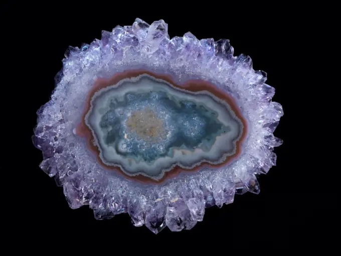 Polished slice of amethyst crystals and agate cut from a geode mined in Artigas, Uruguay.