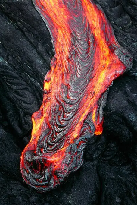 A Stream of Glowing Hot Pahoehoe Lava Oozing Over a Ledge