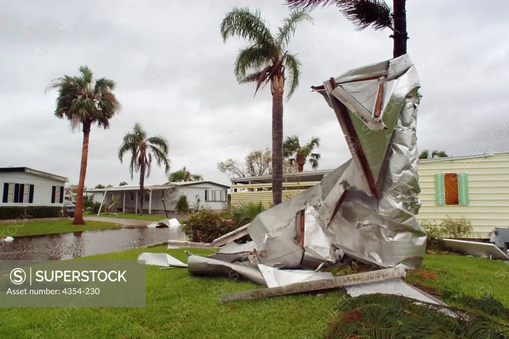 Hurricane Jeanne Twists a Mobile Home Roof Around a Palm Tree