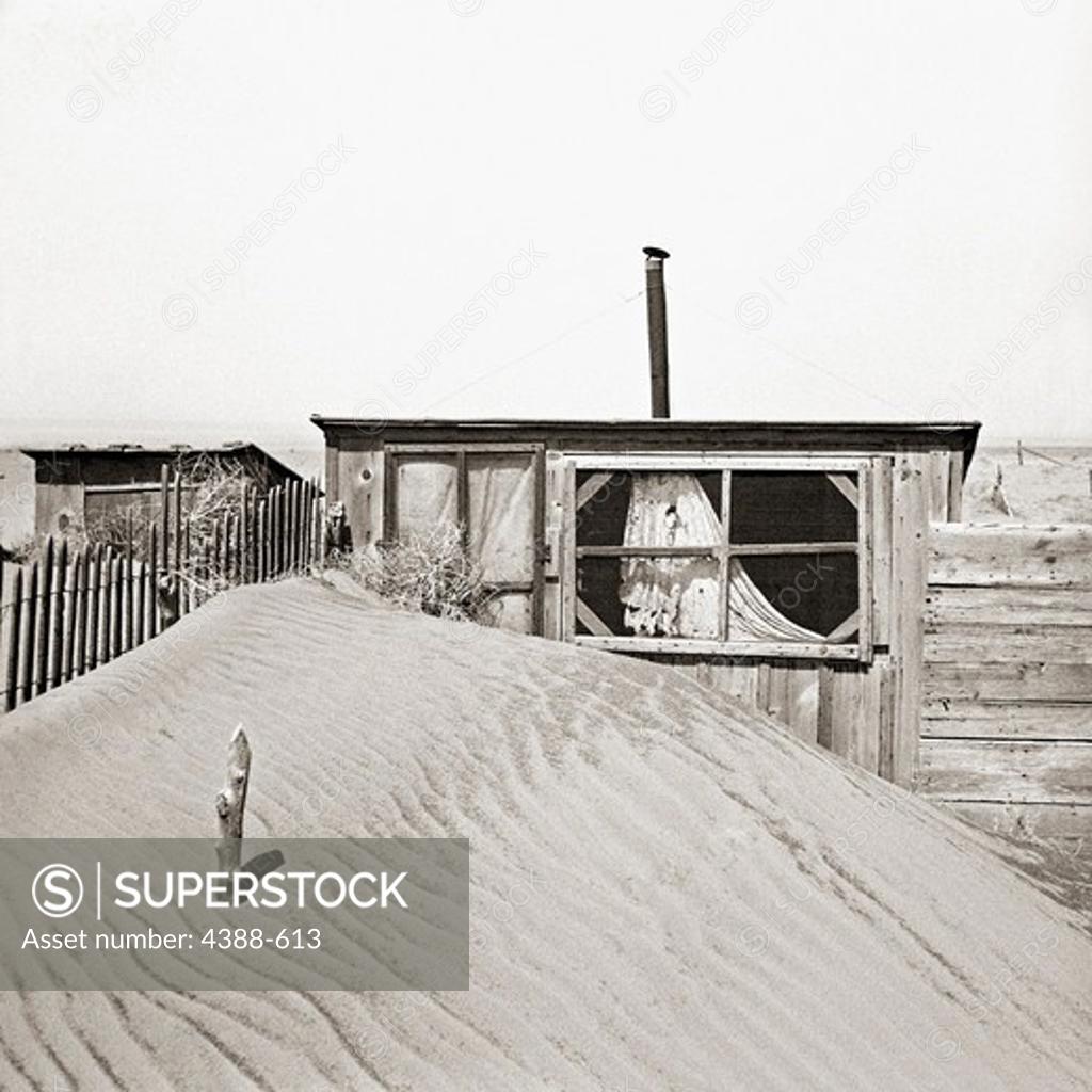 Stock Photo: 4388-613 Sand Piled Against Outhouse