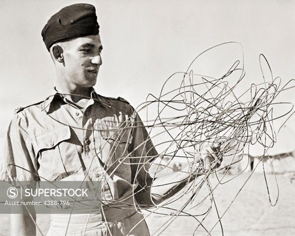 Stock Photo: 4388-796 Sergeant with Scrap Telephone Wire