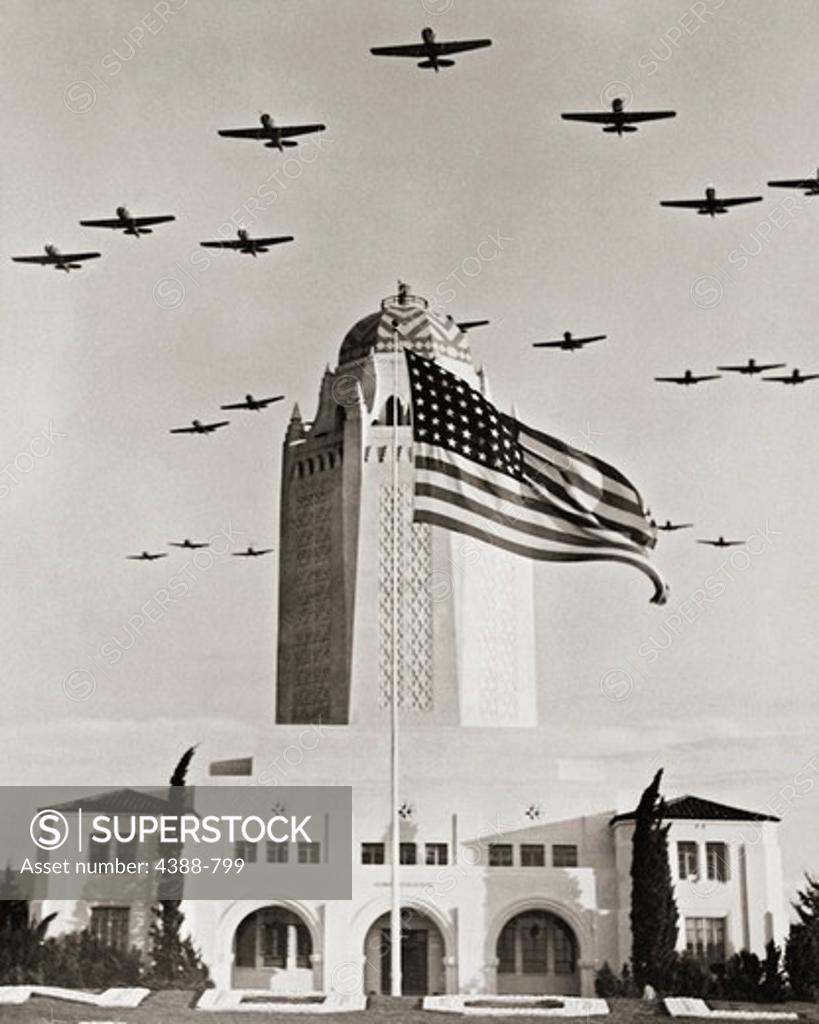 Stock Photo: 4388-799 Fighter Planes Over Administration Building and Flag