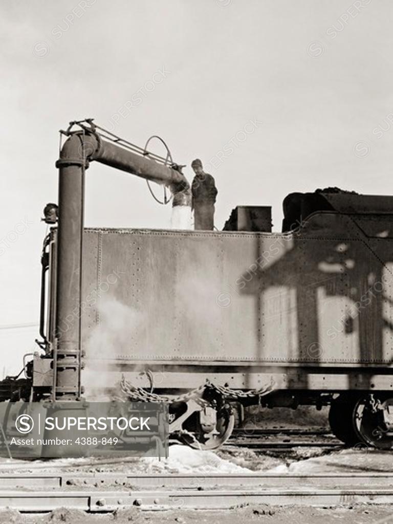 Stock Photo: 4388-849 Watering an Engine