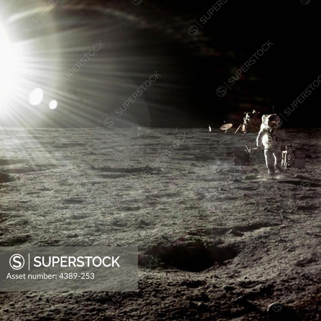 Stock Photo: 4389-253 Apollo 12 - A Blinding Sunrise Lights the Way for an Astronaut on the Surface of the Moon