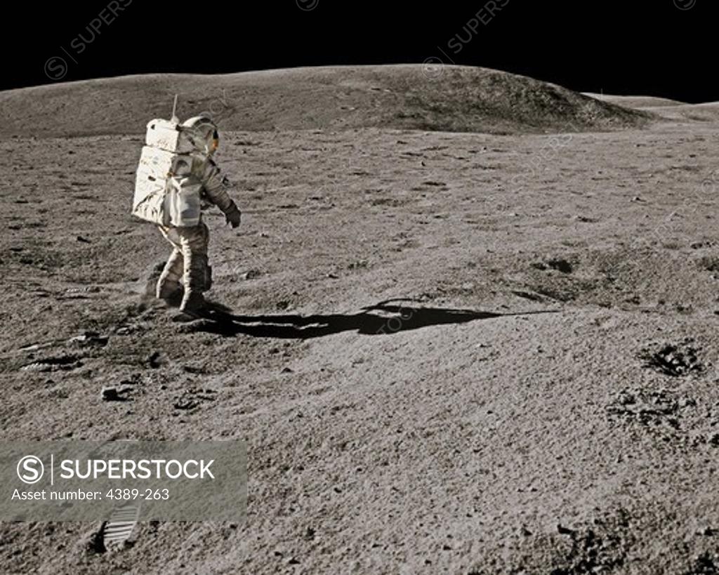 Stock Photo: 4389-263 An Apollo 16 Astronaut Walks the Barren Moon