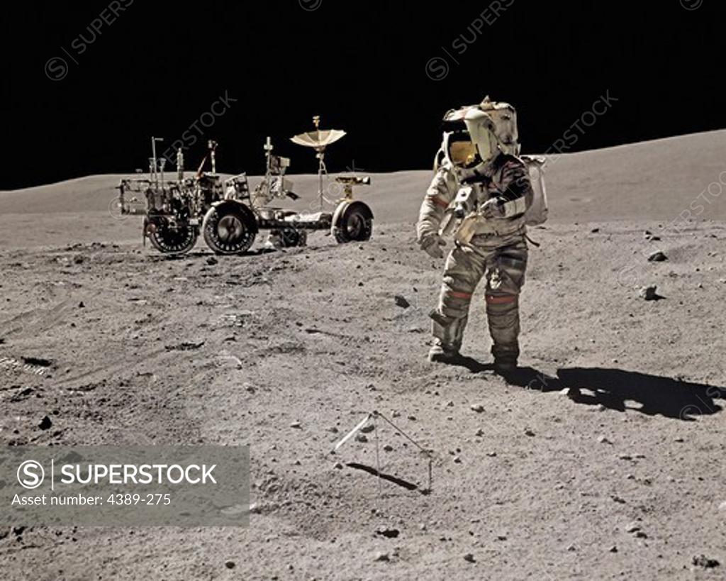 Stock Photo: 4389-275 An Apollo 16 Astronaut Explores Near a Lunar Rover