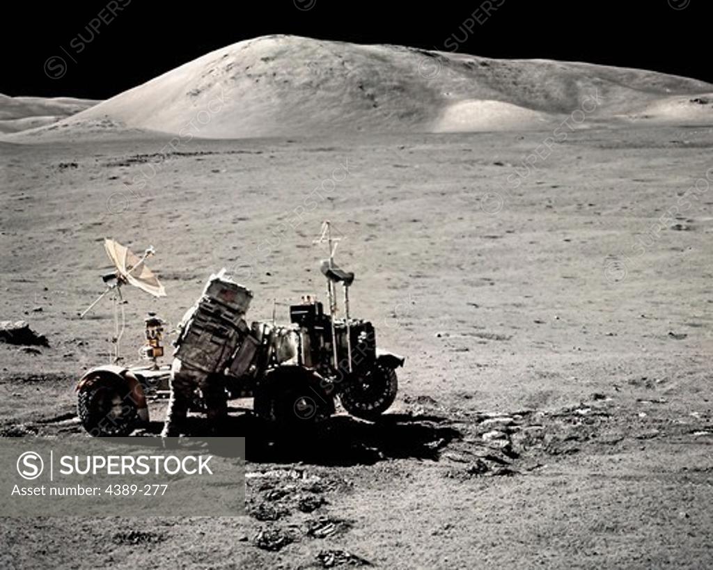 Stock Photo: 4389-277 An Apollo 17 Astronaut and Lunar Rover in a Moon Valley
