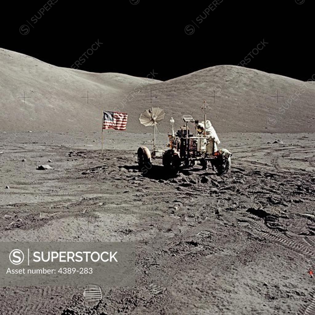 Stock Photo: 4389-283 An Apollo 17 Astronaut and Lunar Rover in a Moon Valley