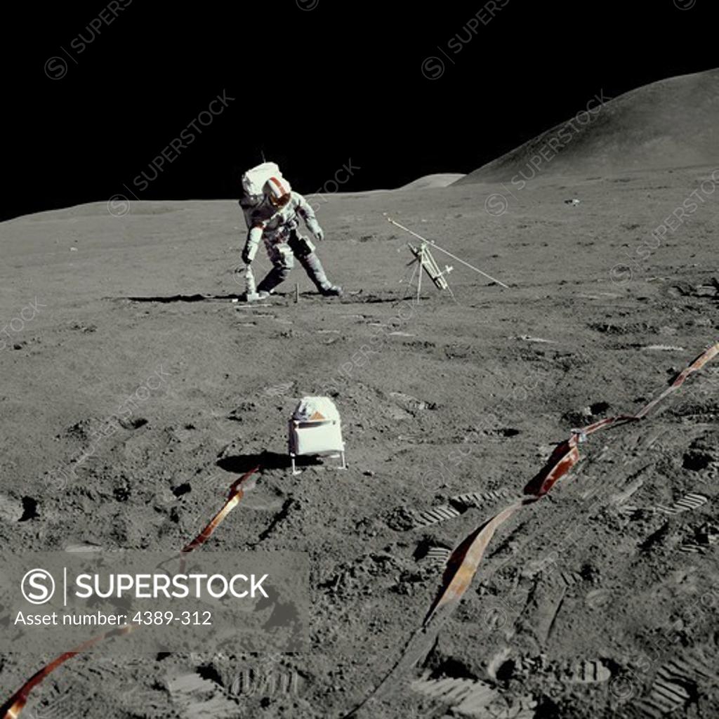 Stock Photo: 4389-312 An Apollo 15 Astronaut Prepping Science Equipment on the Moon