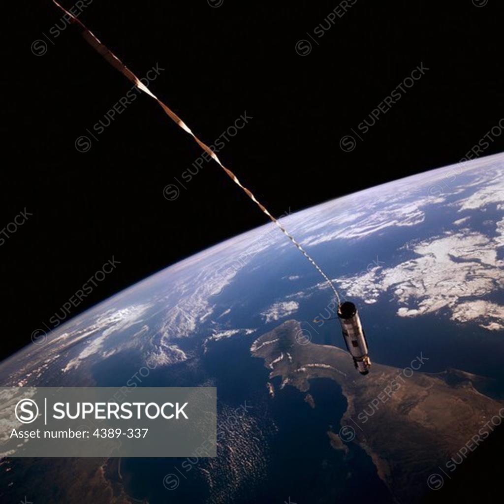 Stock Photo: 4389-337 Agena Rocket Tethered to Gemini 12, Hanging Over the Earth
