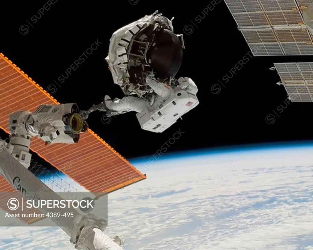 Stock Photo: 4389-495 Astronaut Repairing Gyroscope on International Space Station