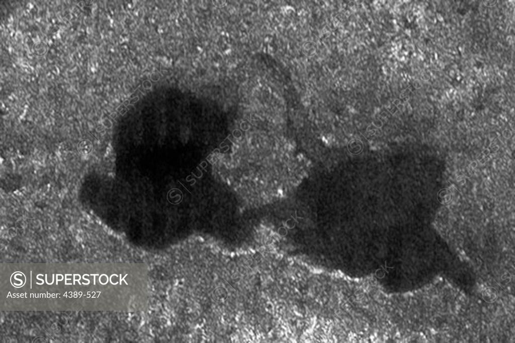 Stock Photo: 4389-527 Cassini Image of Titan's 'Kissing Lakes'