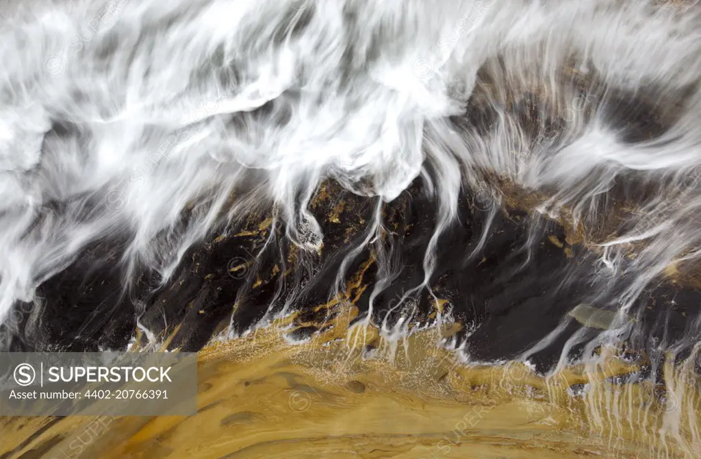 A long exposure blurs a receding wave at Cape Kiwanda, Oregon Coast, USA, 