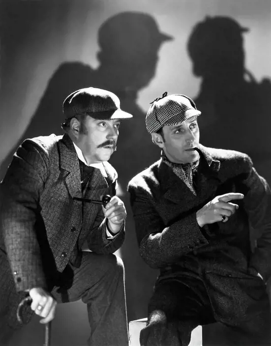 BASIL RATHBONE and NIGEL BRUCE in THE HOUND OF THE BASKERVILLES (1939), directed by SIDNEY LANFIELD.