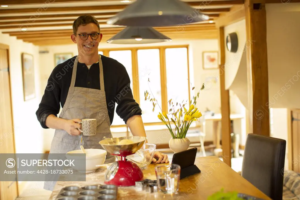 Portrait smiling man baking in kitchen