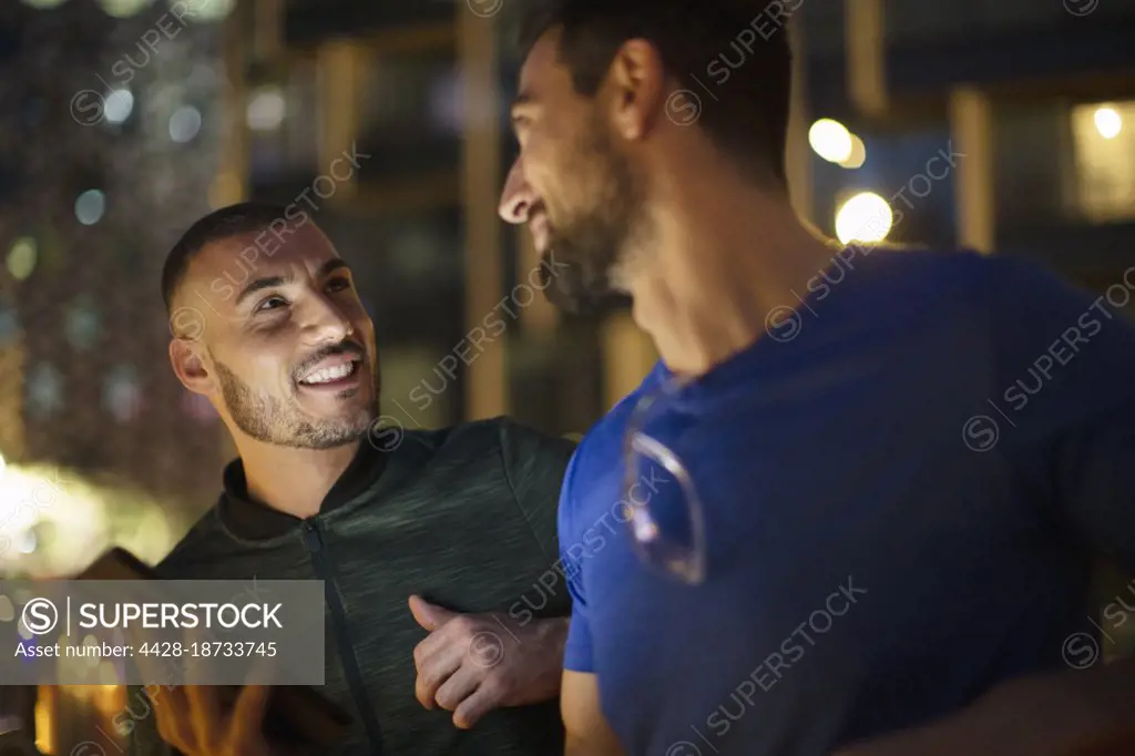Happy men male friends talking at night