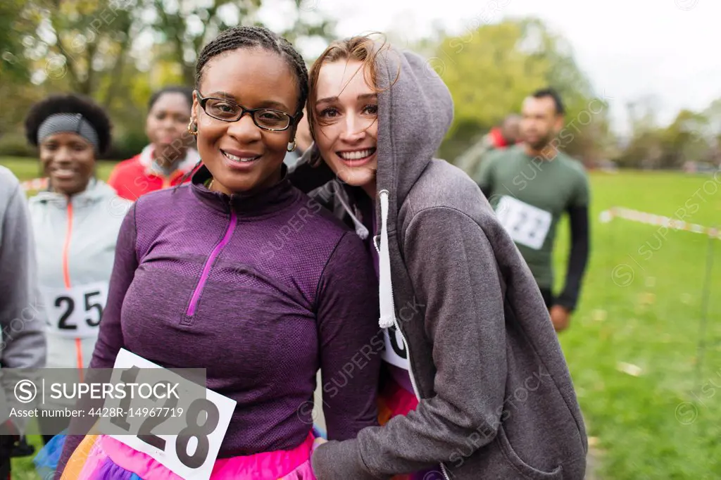 Portrait smiling, confident female runners at charity run in park