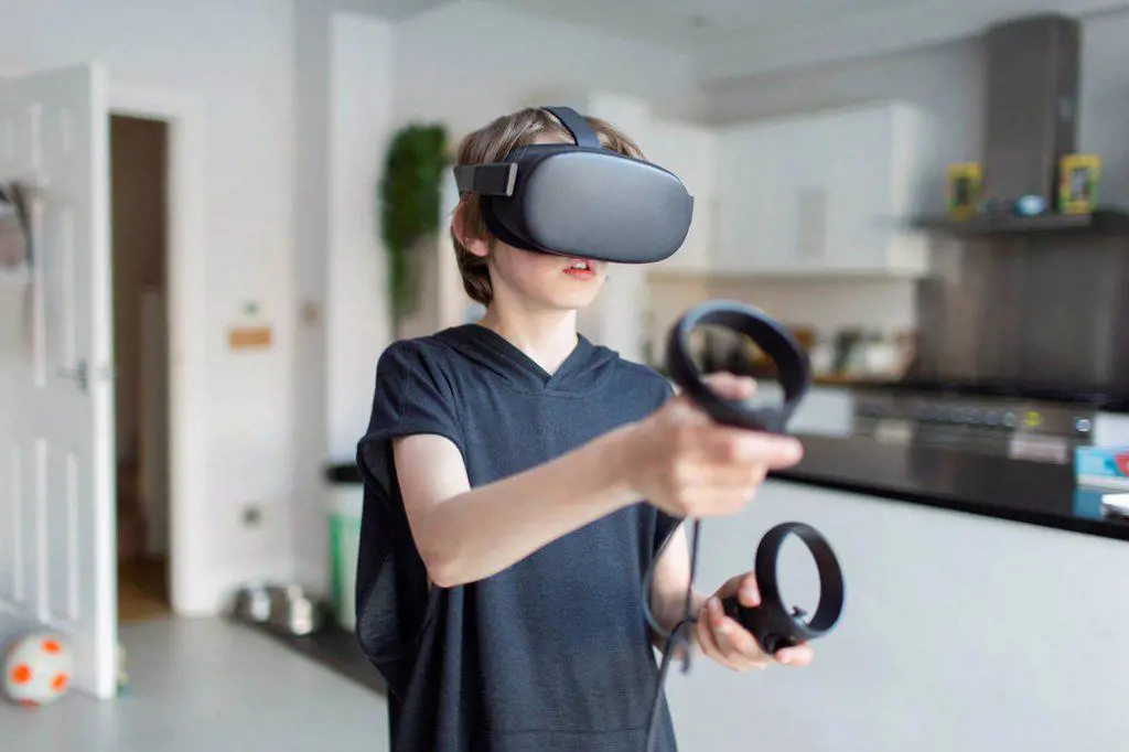 Boy with VRS goggles playing video game