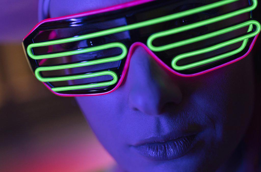 Close up portrait woman in modern neon glasses