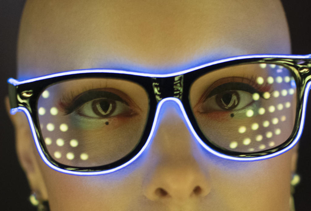 Close up portrait fashionable woman in futuristic neon eyeglasses