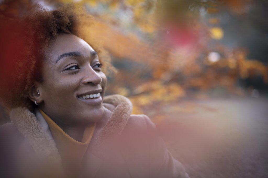 Portrait happy young woman in autumn park