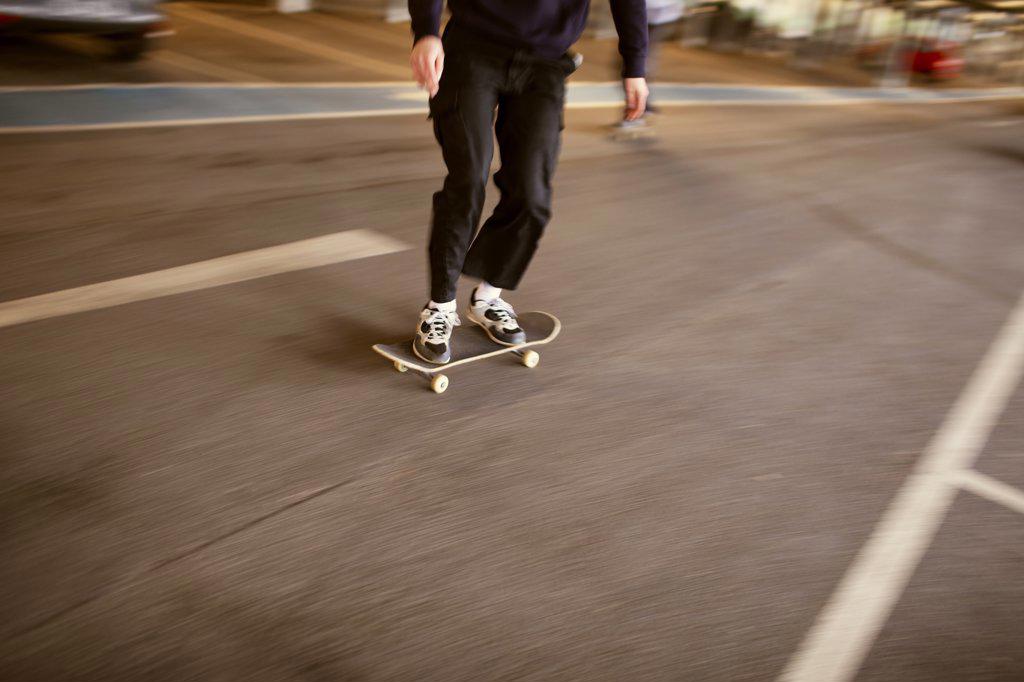 Teenage boy skateboarding on street