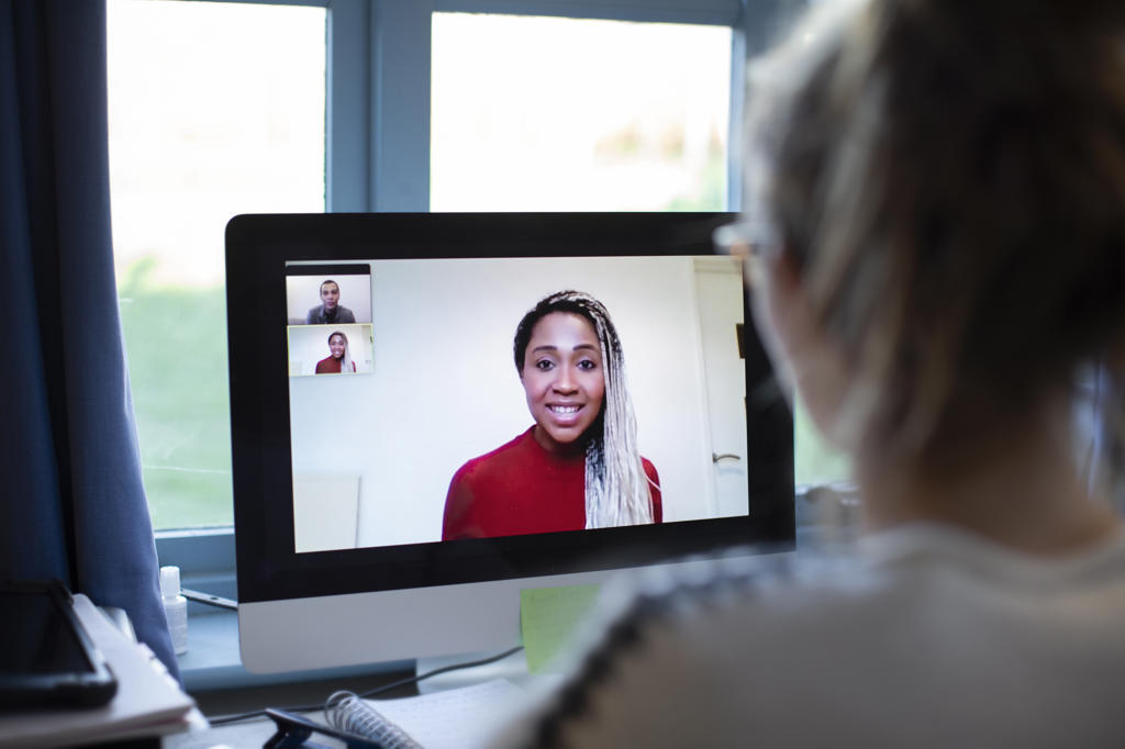 Businesswoman video conferencing with colleagues on computer screen