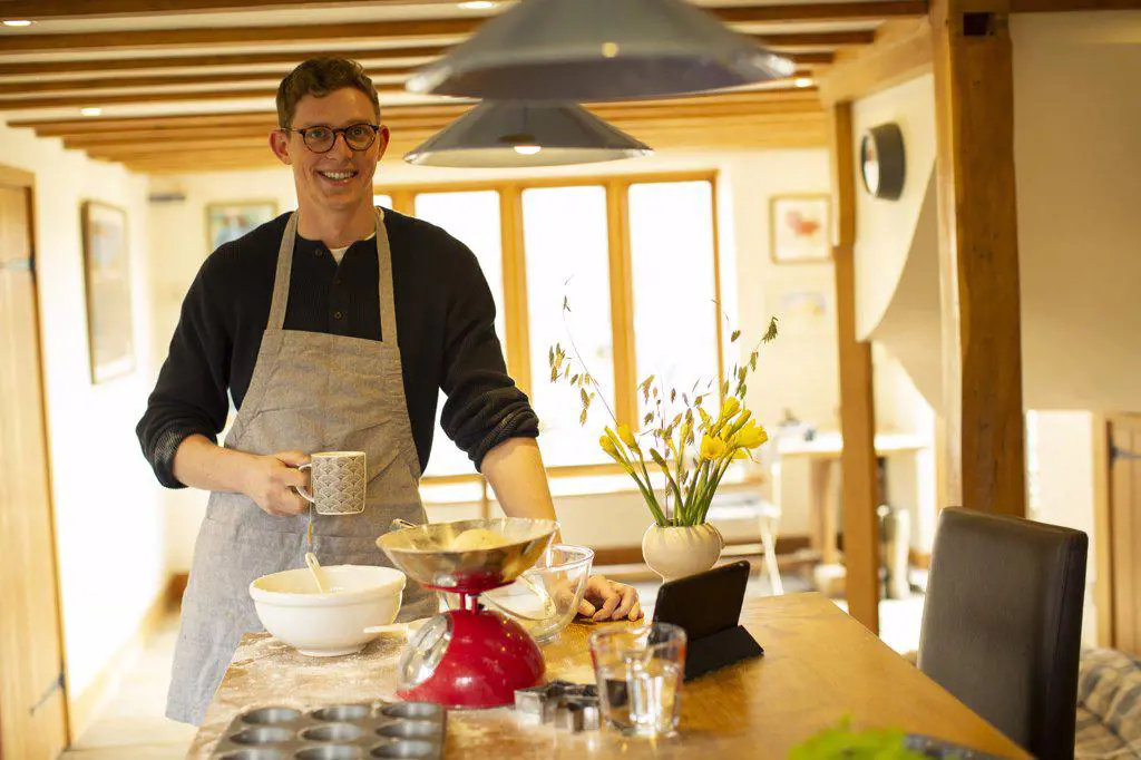 Portrait smiling man baking in kitchen