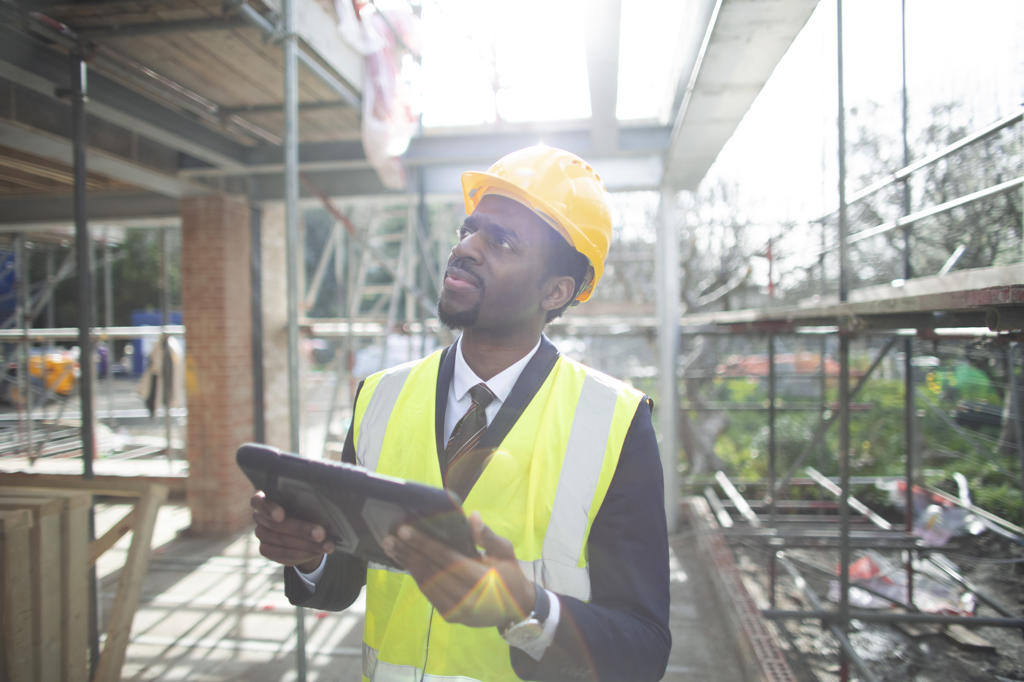 Engineer with digital tablet at construction site