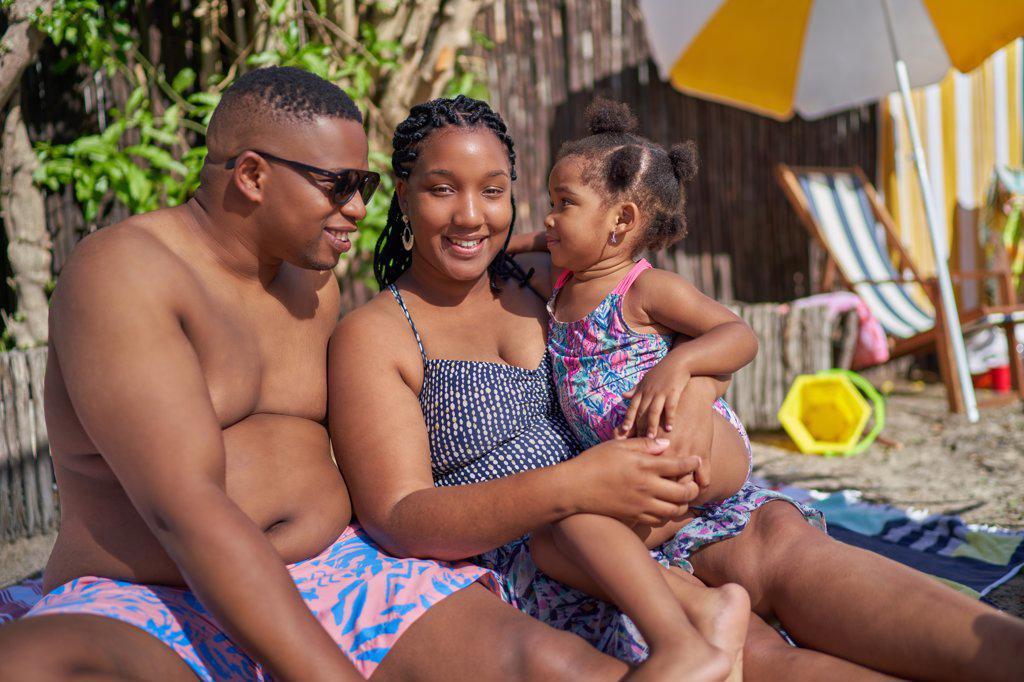 Portrait happy family at summer poolside