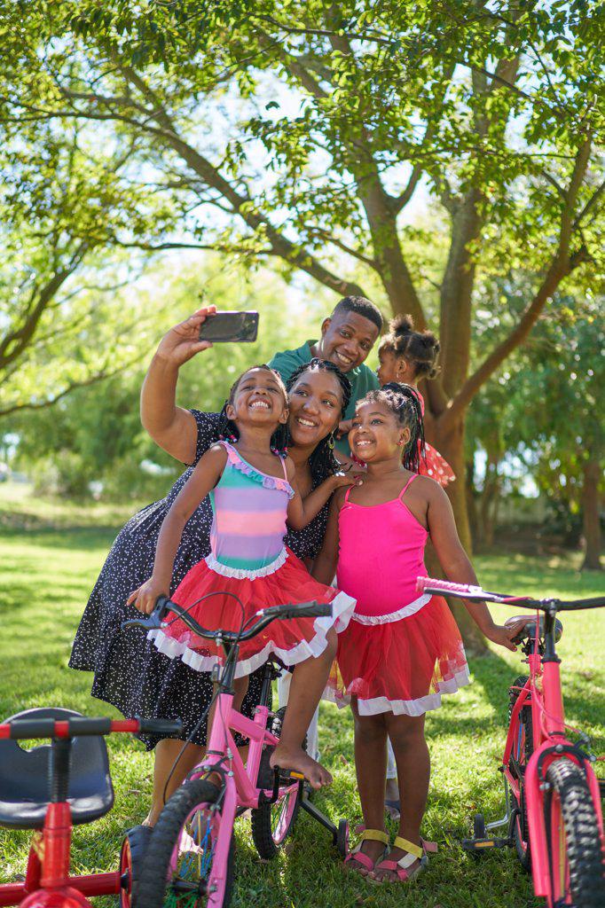 Happy family taking selfie in summer park