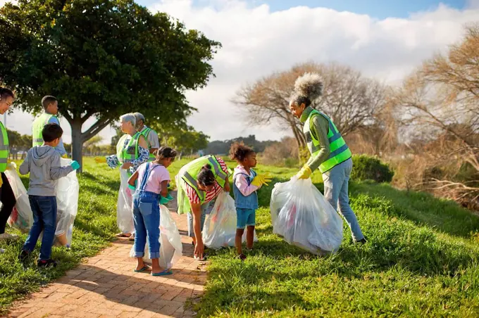 Volunteers cleaning up litter in sunny park