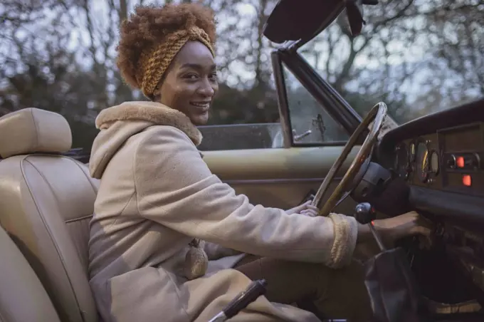 Portrait beautiful young woman driving convertible
