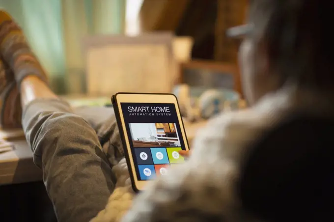 Woman looking at smart home automation on digital tablet screen
