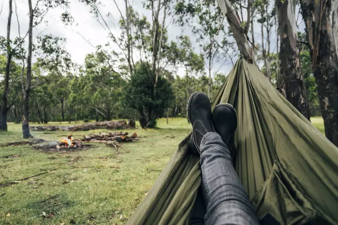 POV man relaxing with feet up at campsite, Australia