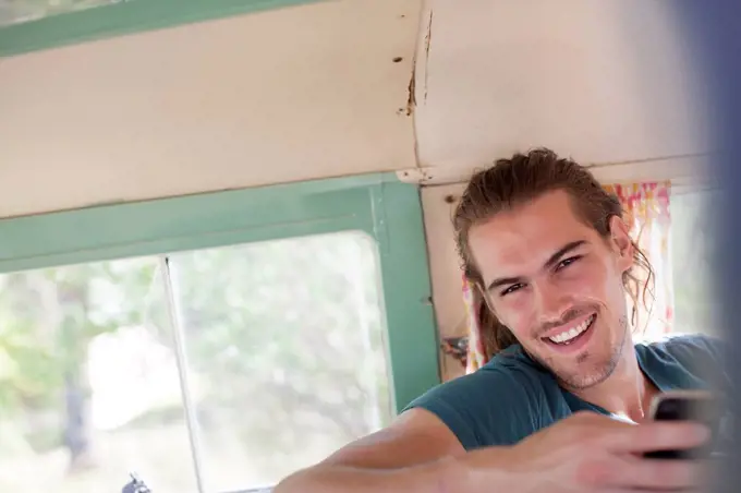 Man smiling in camper van