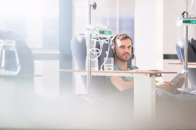 Portrait of man receiving intravenous infusion in hospital