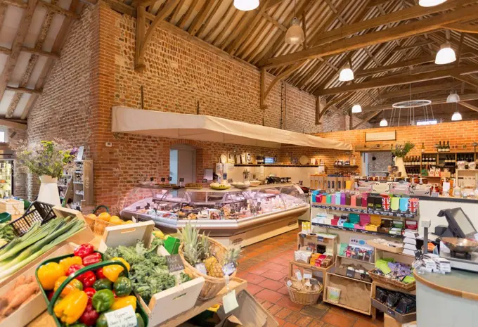 Market with brick walls and wood beam vaulted ceiling