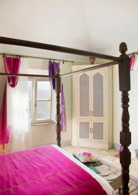 Spain, Four poster bed with purple bedding in bedroom