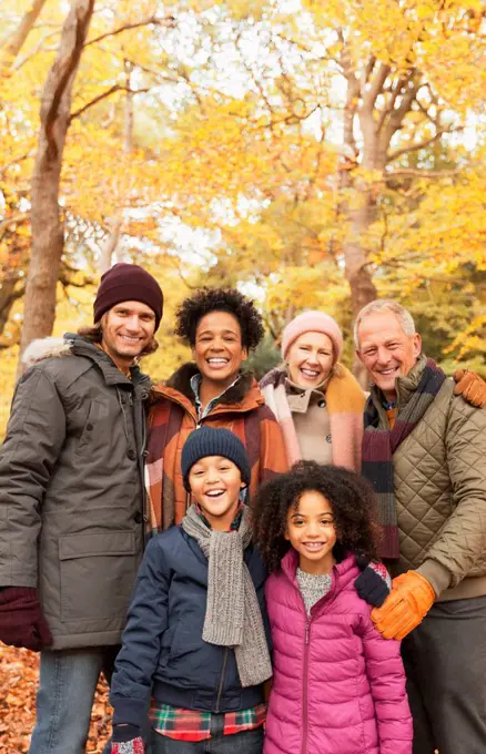 Portrait smiling multi-generation family in autumn woods