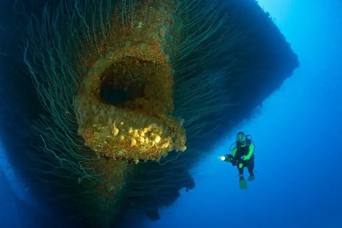 Diver at Anchor Hawse Hole at Bow of USS Saratoga, Marshall Islands, Bikini Atoll, Micronesia, Pacific Ocean
